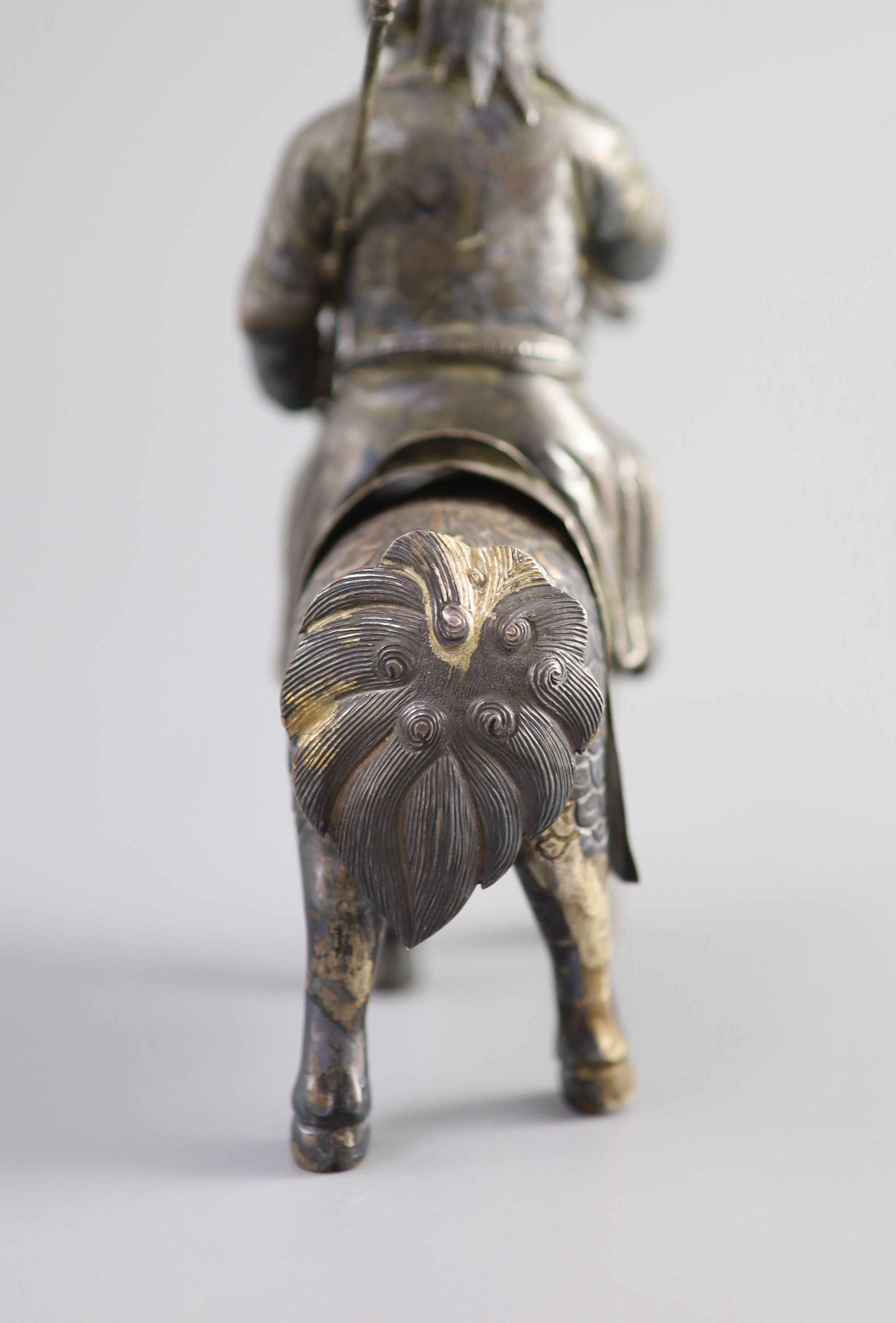 A Chinese white metal model of a boy riding a qilin , early 20th century, 12.5cm long
